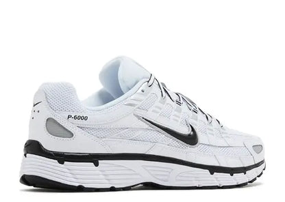 White Nike  running shoe with black accents 